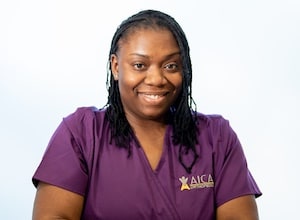 College Park AICA nurse in purple scrubs 