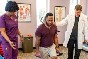 Chamblee Tucker AICA Doctors helping patient with physical therapy
